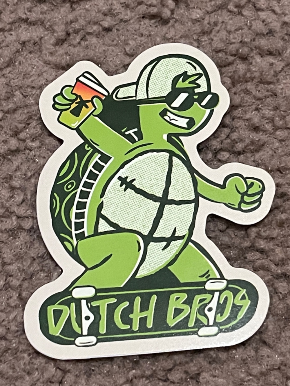 Dutch Bros Lime Green Skate Turtle Sticker with Black and White Accents